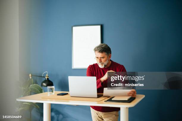 senior businessman working in his modern office - red and white people stock pictures, royalty-free photos & images