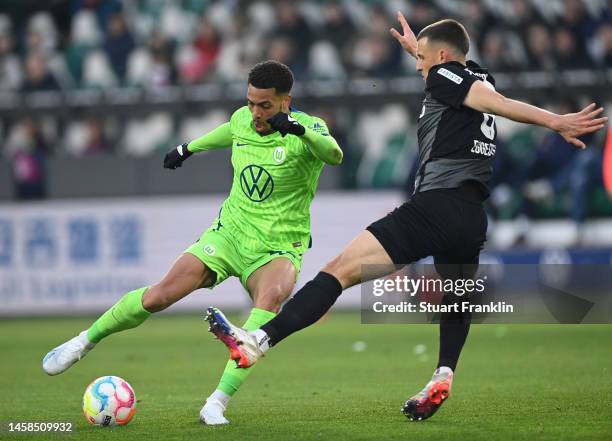 Felix Nmecha of Wolfsburg is challenged by Maximilian Eggestein of Freiburg during the Bundesliga match between VfL Wolfsburg and Sport-Club Freiburg...