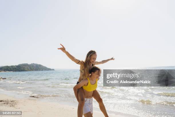 teenage girls spending summer afternoon on the beach - sunny beach stock pictures, royalty-free photos & images