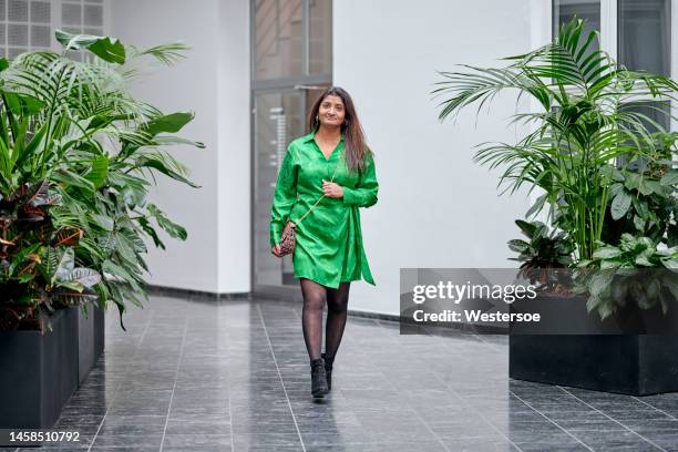 asian woman walking in corridor - emerald stock pictures, royalty-free photos & images