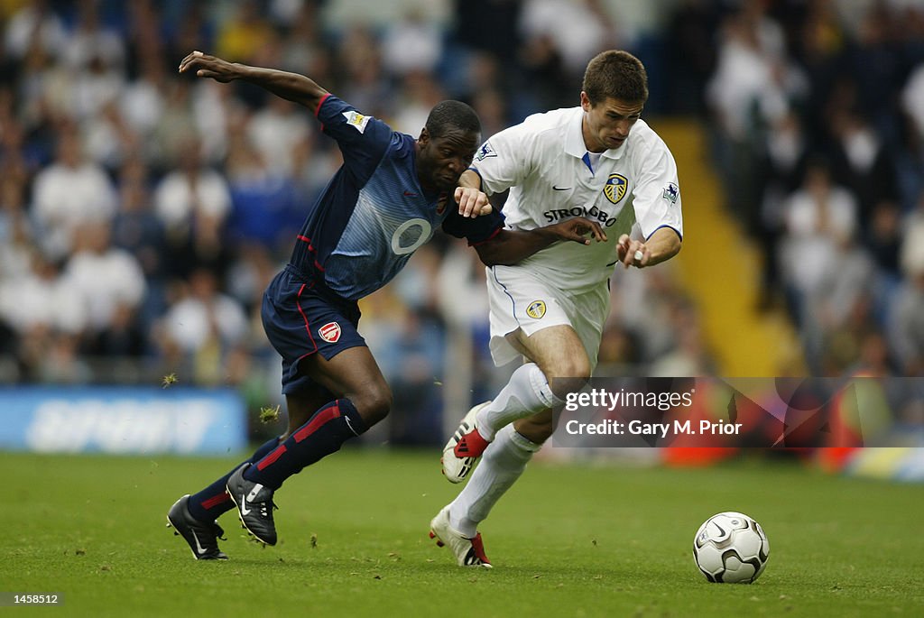 Lauren of Arsenal and Harry Kewell of Leeds United