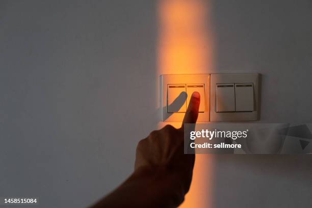 hands touching a control panel illuminated by lights - off stockfoto's en -beelden