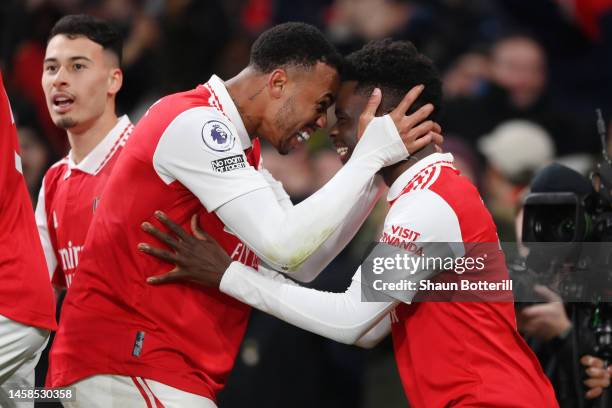 Bukayo Saka celebrates with Gabriel of Arsenal after scoring the team's second goal during the Premier League match between Arsenal FC and Manchester...
