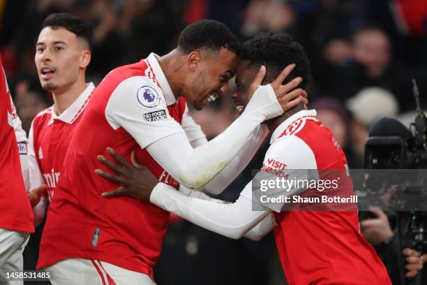 Bukayo Saka celebrates with Gabriel of Arsenal after scoring the team's second goal during the Premier League match between Arsenal FC and Manchester...