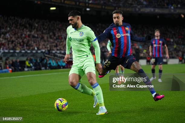 Omar Alderete of Getafe CF is challenged by Raphinha of FC Barcelona during the LaLiga Santander match between FC Barcelona and Getafe CF at Spotify...