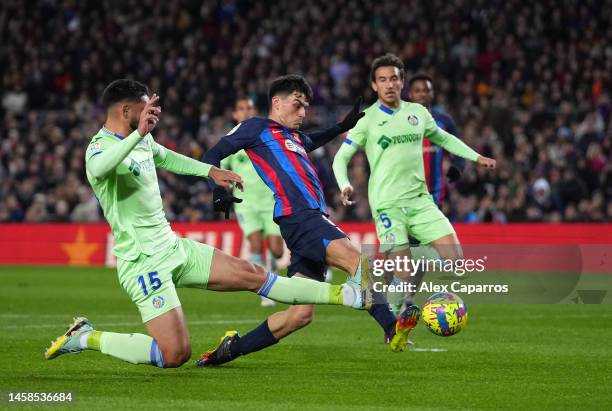 Pedri of FC Barcelona has a shot on goal whilst under pressure from Omar Alderete of Getafe CF during the LaLiga Santander match between FC Barcelona...