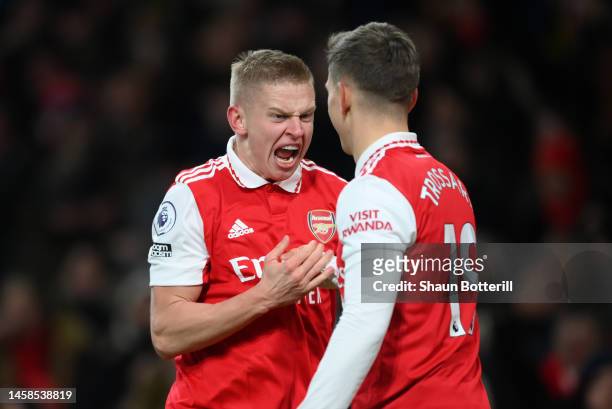 Oleksandr Zinchenko celebrates with Leandro Trossard of Arsenal after their sides third goal during the Premier League match between Arsenal FC and...