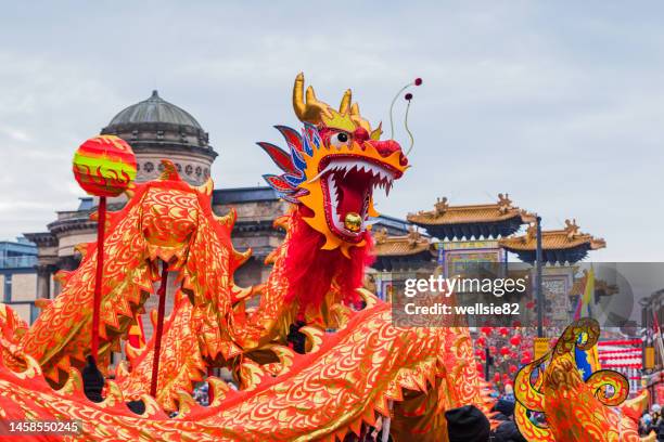 dragon dance in liverpool chinatown - chinese new year dragon dance stock pictures, royalty-free photos & images