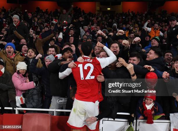 William Saliba celebrates the 3rd goal with the Arsenal fans during the Premier League match between Arsenal FC and Manchester United at Emirates...