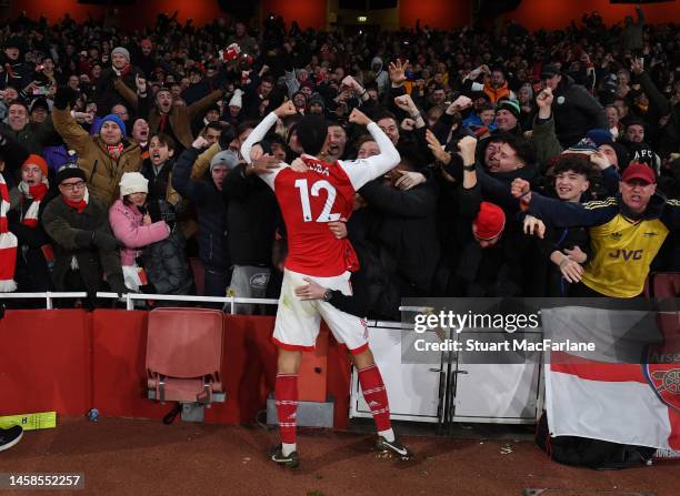 William Saliba celebrates the 3rd goal with the Arsenal fans during the Premier League match between Arsenal FC and Manchester United at Emirates...