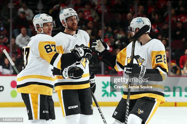 Sidney Crosby of the Pittsburgh Penguins is congratulated by teammates after scoring during the 1st period of the game against the New Jersey Devils...