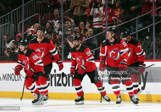 Jack Hughes of the New Jersey Devils is congratulated by teammates after scoring during the 1st period of the game against the Pittsburgh Penguins at...