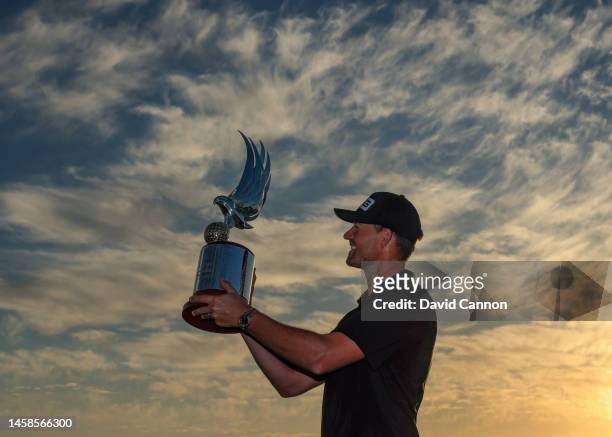 Victor Perez of France holds the Abu Dhabi HSBC Falcon Trophy after the final round on day four of the Abu Dhabi HSBC Championship at Yas Links Golf...