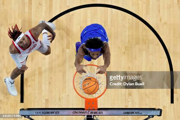 DeAndre Williams of the Memphis Tigers dunks the ball past Jeremiah Davenport of the Cincinnati Bearcats in the first half at Fifth Third Arena on...