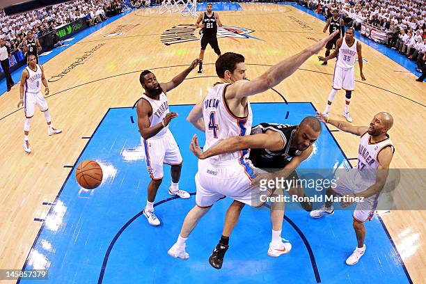 Tony Parker of the San Antonio Spurs passes the ball against James Harden Nick Collison and Derek Fisher of the Oklahoma City Thunder in Game Six of...