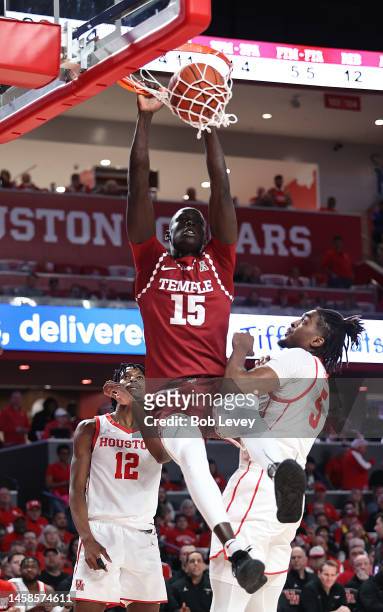 Kur Jongkuch of the Temple Owls dunks over Ja'Vier Francis of the Houston Cougars and Terrance Arceneaux during the first half at Fertitta Center on...