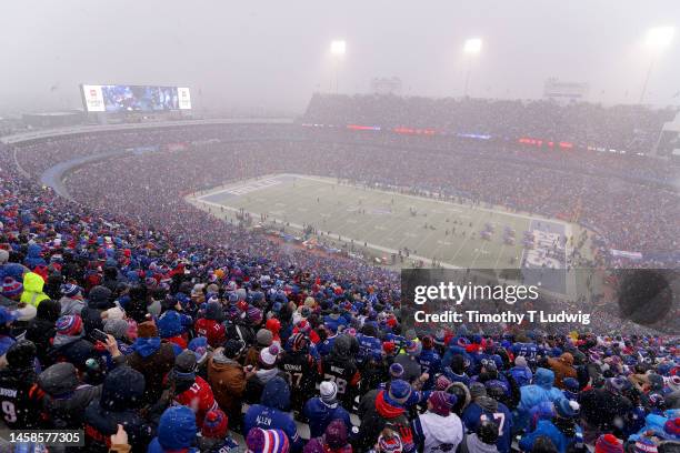 Fans cheer as snow falls during the first half in the AFC Divisional Playoff game between the Cincinnati Bengals and the Buffalo Bills at Highmark...