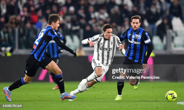 Federico Chiesa of Juventus is challenged by Rafael Toloi and Giorgio Scalvini of Atalanta BC during the Serie A match between Juventus and Atalanta...