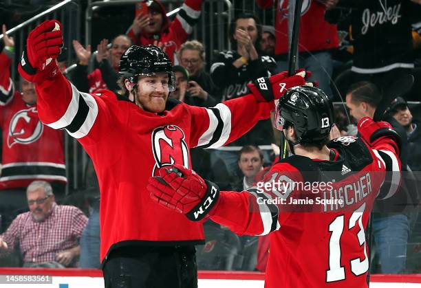 Dougie Hamilton of the New Jersey Devils celebrates with Nico Hischier after scoring the game-winning goal in overtime to win the game against the...