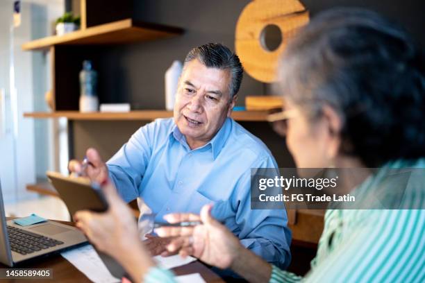 colleagues on a business meeting at the office - baby boomer working stock pictures, royalty-free photos & images