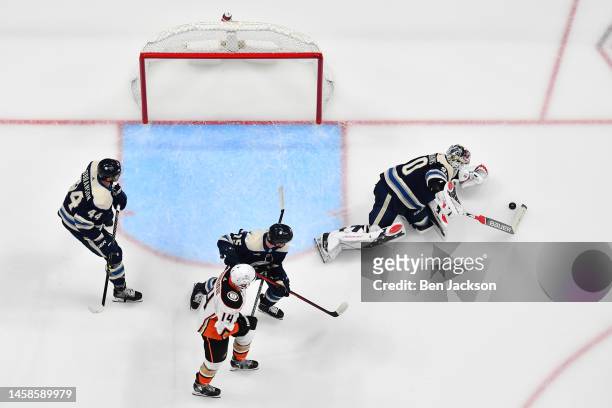 Goaltender Elvis Merzlikins of the Columbus Blue Jackets collects a loose puck during the second period of a game against the Anaheim Ducks at...