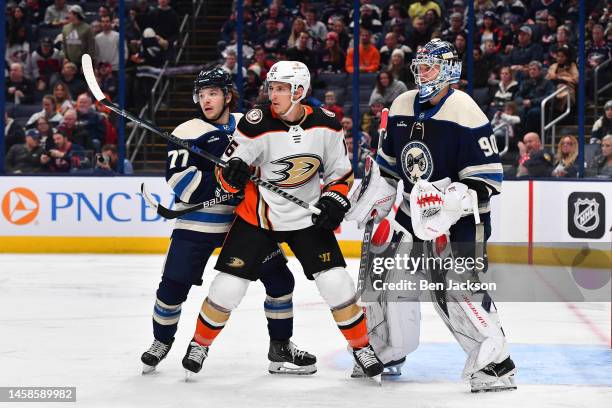 Nick Blankenburg of the Columbus Blue Jackets and Ryan Strome of the Anaheim Ducks battle for position in front of goaltender Elvis Merzlikins of the...