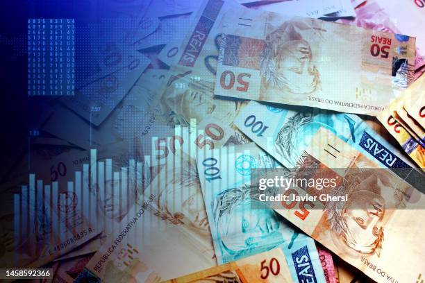 brazilian reais banknotes in cash and stock market indicators - latin america background stock pictures, royalty-free photos & images