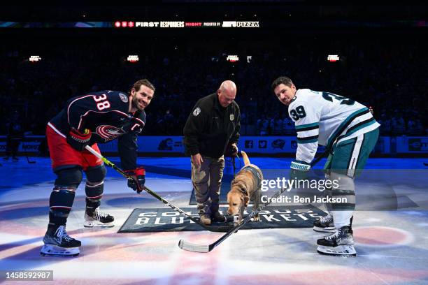 Columbus Division of police therapy dog Simon drops the puck for Boone Jenner of the Columbus Blue Jackets and Logan Couture of the San Jose Sharks...