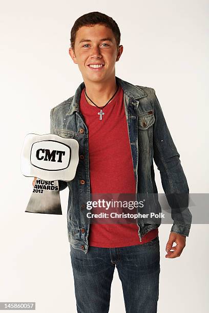 Scotty McCreery poses with award in the Wonderwall.com.com Portrait Studio during 2012 CMT Music awards at the Bridgestone Arena on June 6, 2012 in...