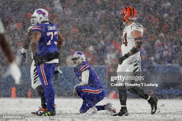 Josh Allen of the Buffalo Bills kneels on the field after a play against the Cincinnati Bengals during the fourth quarter in the AFC Divisional...