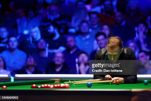 Judd Trump of England reacts after playing a shot during the 2023 World Grand Prix final match against Mark Allen of Northern Ireland at Centaur...