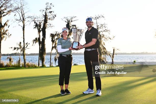 Brooke Henderson of Canada and Mardy Fish of the United States pose with the trophy after winning the Hilton Grand Vacations Tournament of Champions...