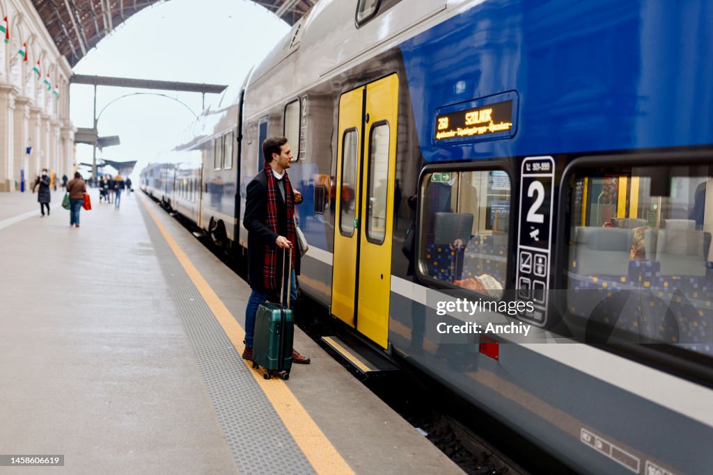 Train passenger entering commuter carriage