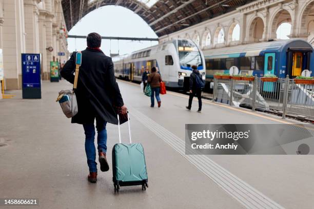 man trying to catch the train - catching train stock pictures, royalty-free photos & images