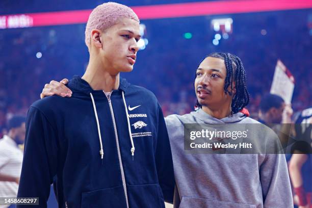 Injured players Trevon Brazile and Nick Smith Jr. #3 of the Arkansas Razorbacks talk before a game against the Mississippi Rebels at Bud Walton Arena...