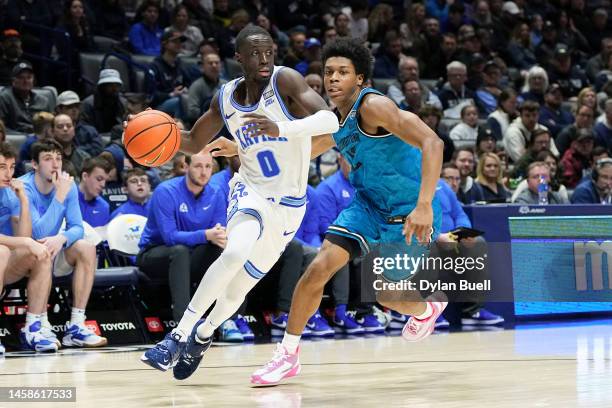 Souley Boum of the Xavier Musketeers dribbles the ball while being guarded by Jordan Riley of the Georgetown Hoyas in the second half at the Cintas...