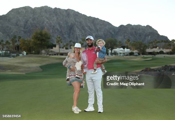 Jon Rahm of Spain celebrates with the trophy alongside wife Kelley, sons Kepa Cahill Rahm and Eneko Cahill Rahm after winning during the final round...