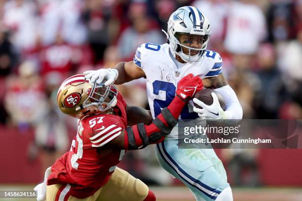 Tony Pollard of the Dallas Cowboys carries the ball against Dre Greenlaw of the San Francisco 49ers during the second quarter in the NFC Divisional...