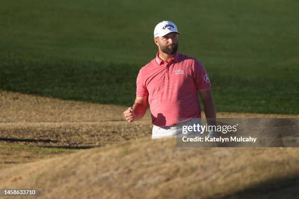 Jon Rahm of Spain reacts after playing a shot from a bunker on the 18th hole during the final round of The American Express at PGA West Pete Dye...