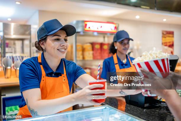 attendant delivering popcorn and soda - fastfoodrestaurant stockfoto's en -beelden