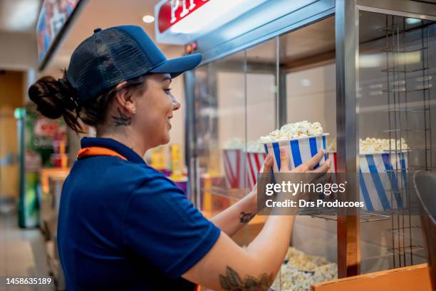 attendant delivering popcorn to customers - film festival concept stock pictures, royalty-free photos & images