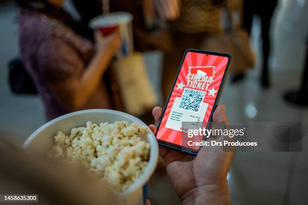 person using mobile app for cinema entrance - cinema ticket stock pictures, royalty-free photos & images