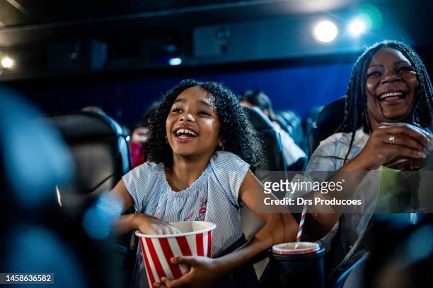 excited girl watching movie in cinema - movie theater imagens e fotografias de stock