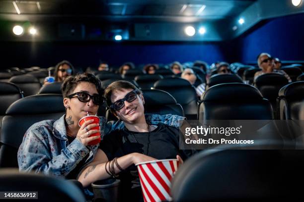 trans man with his girlfriend at the cinema - 3d adult movie stockfoto's en -beelden