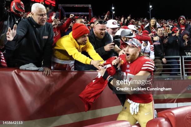 George Kittle of the San Francisco 49ers celebrates with fans after defeating the Dallas Cowboys 19-12 in the NFC Divisional Playoff game at Levi's...