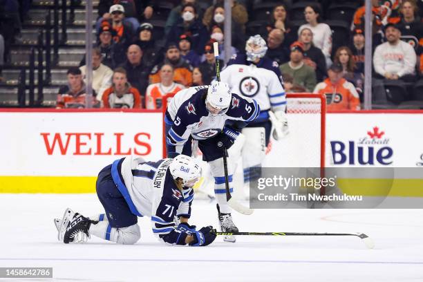 Axel Jonsson-Fjallby and Brenden Dillon of the Winnipeg Jets react during the third period against the Philadelphia Flyers at Wells Fargo Center on...