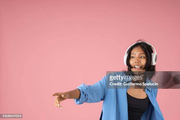 young woman enjoying listening to music - fabolous in concert stock pictures, royalty-free photos & images