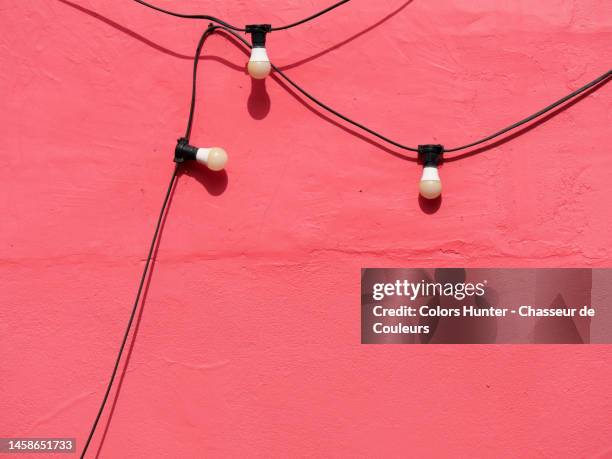 clean wall painted red with string light turned off in london - surrounding wall stock pictures, royalty-free photos & images