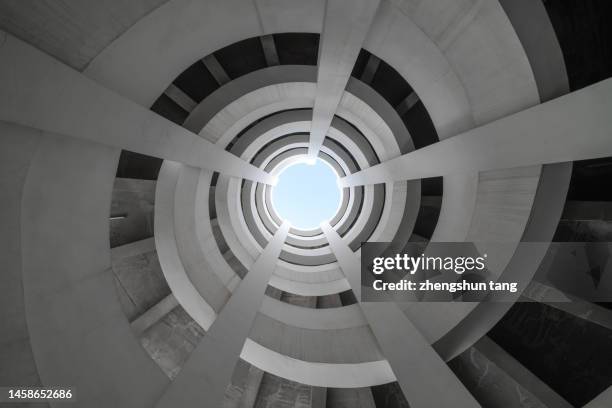 low angle view of spiral roadway in a parking garage - building symmetry stock pictures, royalty-free photos & images