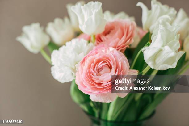 vase with spring flowers tulips, cloves and buttercups in home interior. mother's day. 8 march and easter concept - ranunculus stock pictures, royalty-free photos & images